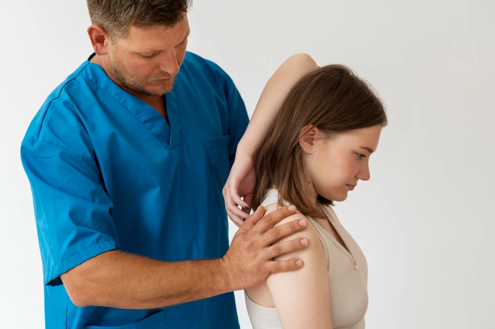 Physiotherapist performing shoulder and neck treatment for Thoracic Outlet Syndrome