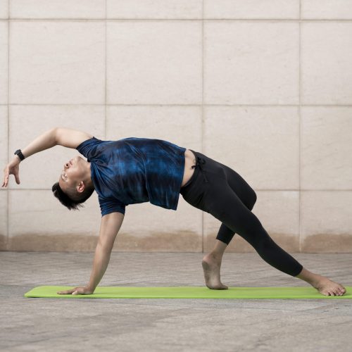 man-doing-yoga-outside-mat-with-copy-space.jpg